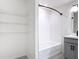 Bathroom featuring a bathtub with white tile and open shelving on the left at 2836 Sanctuary Dr, Clermont, FL 34714