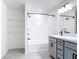 Bright bathroom showcasing a white tiled shower, dual sink vanity, and open shelving at 2836 Sanctuary Dr, Clermont, FL 34714