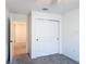 Bedroom featuring a sliding door closet, neutral carpeting and convenient access to other rooms at 2836 Sanctuary Dr, Clermont, FL 34714