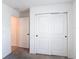 Bedroom featuring sliding door closet, neutral carpeting and convenient access to other rooms at 2836 Sanctuary Dr, Clermont, FL 34714
