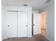 Bedroom featuring a sliding door closet, neutral carpeting and convenient access to other rooms at 2836 Sanctuary Dr, Clermont, FL 34714