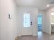 Bright entryway with a modern front door, tile flooring, and recessed lighting at 2836 Sanctuary Dr, Clermont, FL 34714