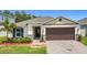 Charming single-story home with a two-car garage, landscaped yard and neutral color palette at 2836 Sanctuary Dr, Clermont, FL 34714