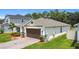 Single-story home featuring a paver driveway and meticulously maintained landscaping at 2836 Sanctuary Dr, Clermont, FL 34714