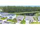 Attractive single-Gathering homes with manicured lawns nestled beside a serene pond and verdant forest backdrop at 2836 Sanctuary Dr, Clermont, FL 34714