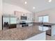 Modern kitchen features stainless steel appliances, granite countertops, and ample cabinet space at 2836 Sanctuary Dr, Clermont, FL 34714