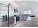 Modern kitchen features stainless steel appliances, granite countertops, and ample cabinet space at 2836 Sanctuary Dr, Clermont, FL 34714