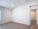 Open living room with neutral tile flooring, a bright atmosphere, and access to additional rooms at 2836 Sanctuary Dr, Clermont, FL 34714