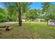 This spacious backyard includes mature trees, space for games, and an outdoor shed for storage at 2901 Autumnwood Trl, Apopka, FL 32703