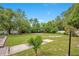 Enjoy a sprawling backyard with a volleyball court, mature trees, and potential for various outdoor activities at 2901 Autumnwood Trl, Apopka, FL 32703
