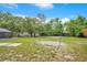 Large backyard with a sand volleyball court and ample space for other activities and relaxing at 2901 Autumnwood Trl, Apopka, FL 32703