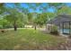 The expansive backyard features lush greenery, mature trees, and potential for outdoor activities and relaxation at 2901 Autumnwood Trl, Apopka, FL 32703