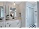 Clean bathroom with a single sink vanity, framed mirror, and a walk-in shower at 2901 Autumnwood Trl, Apopka, FL 32703
