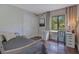 Bright bedroom with a large window, desk space, and wood flooring at 2901 Autumnwood Trl, Apopka, FL 32703