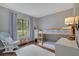 Cozy bedroom features a bunk bed, white rug, and ample natural light at 2901 Autumnwood Trl, Apopka, FL 32703