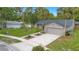 Charming single-Gathering home featuring a well-manicured lawn and a spacious driveway leading to an attached garage at 2901 Autumnwood Trl, Apopka, FL 32703