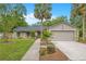 Well-maintained single-Gathering home with a lush lawn, mature trees, and inviting curb appeal on a sunny day at 2901 Autumnwood Trl, Apopka, FL 32703