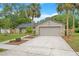 Charming single-story home with stone accents, manicured lawn, and two-car garage on a sunny day at 2901 Autumnwood Trl, Apopka, FL 32703