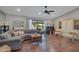 Spacious living room with hardwood floors, and a large sectional sofa perfect for relaxing and entertaining at 2901 Autumnwood Trl, Apopka, FL 32703