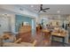 Open-concept living room featuring hardwood floors, ample natural light, and an adjacent dining area at 2901 Autumnwood Trl, Apopka, FL 32703