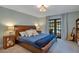 Comfortable main bedroom with a king-size bed and French doors to outdoor space at 2901 Autumnwood Trl, Apopka, FL 32703