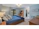 Serene main bedroom with French doors leading to a pool view and natural light at 2901 Autumnwood Trl, Apopka, FL 32703