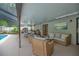 Covered patio with lounge seating, a ping pong table, and a view of the pool at 2901 Autumnwood Trl, Apopka, FL 32703