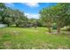 Picturesque park view featuring open green space, mature trees, and recreational amenities at 2901 Autumnwood Trl, Apopka, FL 32703