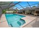 An inviting screened-in pool with multiple seating areas and lush landscaping at 2901 Autumnwood Trl, Apopka, FL 32703