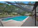 A serene backyard view of a screened-in pool with an expansive patio area and well-manicured landscaping at 2901 Autumnwood Trl, Apopka, FL 32703