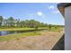 Backyard showcasing a serene waterway view, complete with lush greenery and mature trees at 3210 Viceroy Ct, Poinciana, FL 34759