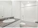 The bathroom boasts modern fixtures, a granite countertop, and a combined tub and shower at 3210 Viceroy Ct, Poinciana, FL 34759