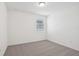 Bedroom with neutral carpet, white walls, and a single window at 3210 Viceroy Ct, Poinciana, FL 34759