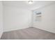 A well-lit, carpeted bedroom with a window and doorway offers a comfortable and inviting space at 3210 Viceroy Ct, Poinciana, FL 34759