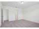 Bedroom with neutral carpet, white walls, two doorways, and one window at 3210 Viceroy Ct, Poinciana, FL 34759