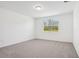 Simple bedroom with neutral carpet, one window, and white walls at 3210 Viceroy Ct, Poinciana, FL 34759