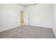 A carpeted bedroom features neutral walls, open doorway and carpeted floors at 3210 Viceroy Ct, Poinciana, FL 34759