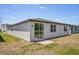 Backyard with a sliding glass door and a small brick patio, offering outdoor access at 3210 Viceroy Ct, Poinciana, FL 34759