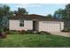 Charming single-story home with a well-manicured lawn and colorful landscaping at 3210 Viceroy Ct, Poinciana, FL 34759