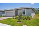 New home featuring a well-maintained lawn and complementary landscaping at 3210 Viceroy Ct, Poinciana, FL 34759