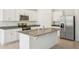 Bright kitchen with stainless steel appliances, granite countertops, and white cabinetry at 3210 Viceroy Ct, Poinciana, FL 34759