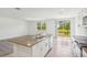 Bright kitchen with a large island, stainless steel appliances, and sliding glass doors to the backyard at 3210 Viceroy Ct, Poinciana, FL 34759
