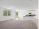 Spacious living room and open kitchen area with sliding glass doors to lanai at 3210 Viceroy Ct, Poinciana, FL 34759