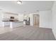 Open concept living area flows into a kitchen with white cabinetry and stainless steel appliances at 3210 Viceroy Ct, Poinciana, FL 34759
