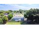 Aerial view of house featuring large backyard and canopy on concrete patio at 344 Buenaventura Blvd, Kissimmee, FL 34743