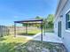 Fenced backyard featuring a canopy with concrete patio and lawn at 344 Buenaventura Blvd, Kissimmee, FL 34743