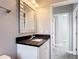 Bathroom featuring modern vanity with granite countertop and unique framed mirror at 344 Buenaventura Blvd, Kissimmee, FL 34743