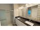Modern bathroom with dual sinks, granite countertops, and a walk-in shower at 344 Buenaventura Blvd, Kissimmee, FL 34743