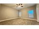 Bright bedroom with wood-look tile flooring and two windows for ample natural light at 344 Buenaventura Blvd, Kissimmee, FL 34743