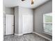 Bedroom featuring wood-look floors, a double door closet and a window at 344 Buenaventura Blvd, Kissimmee, FL 34743